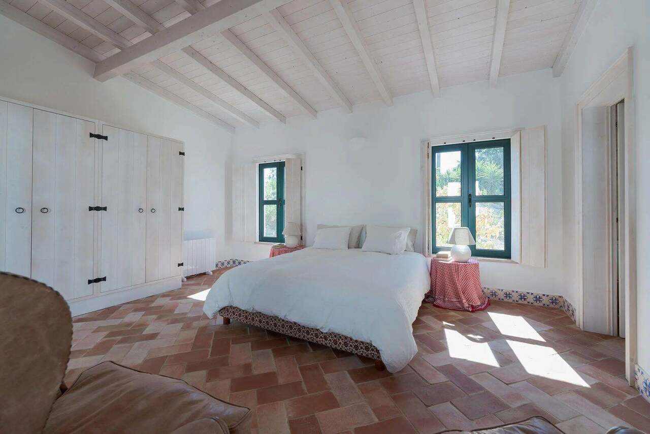 A double bedroom with green shutters