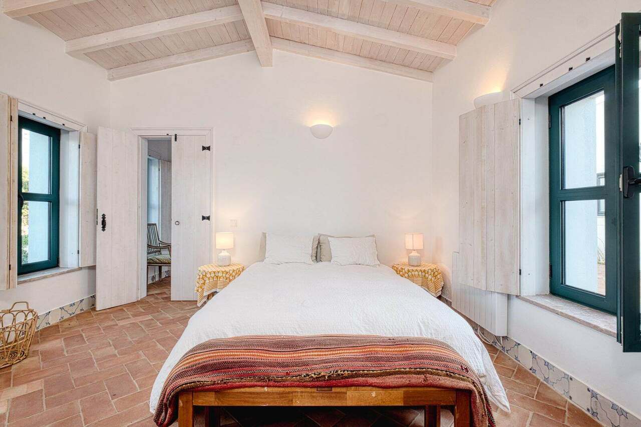 A double bedroom with green shutters