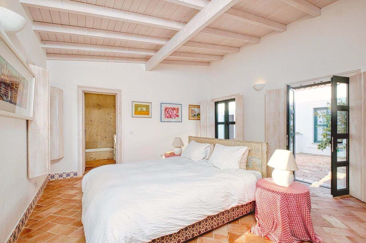 A double bedroom with French doors to the garden
