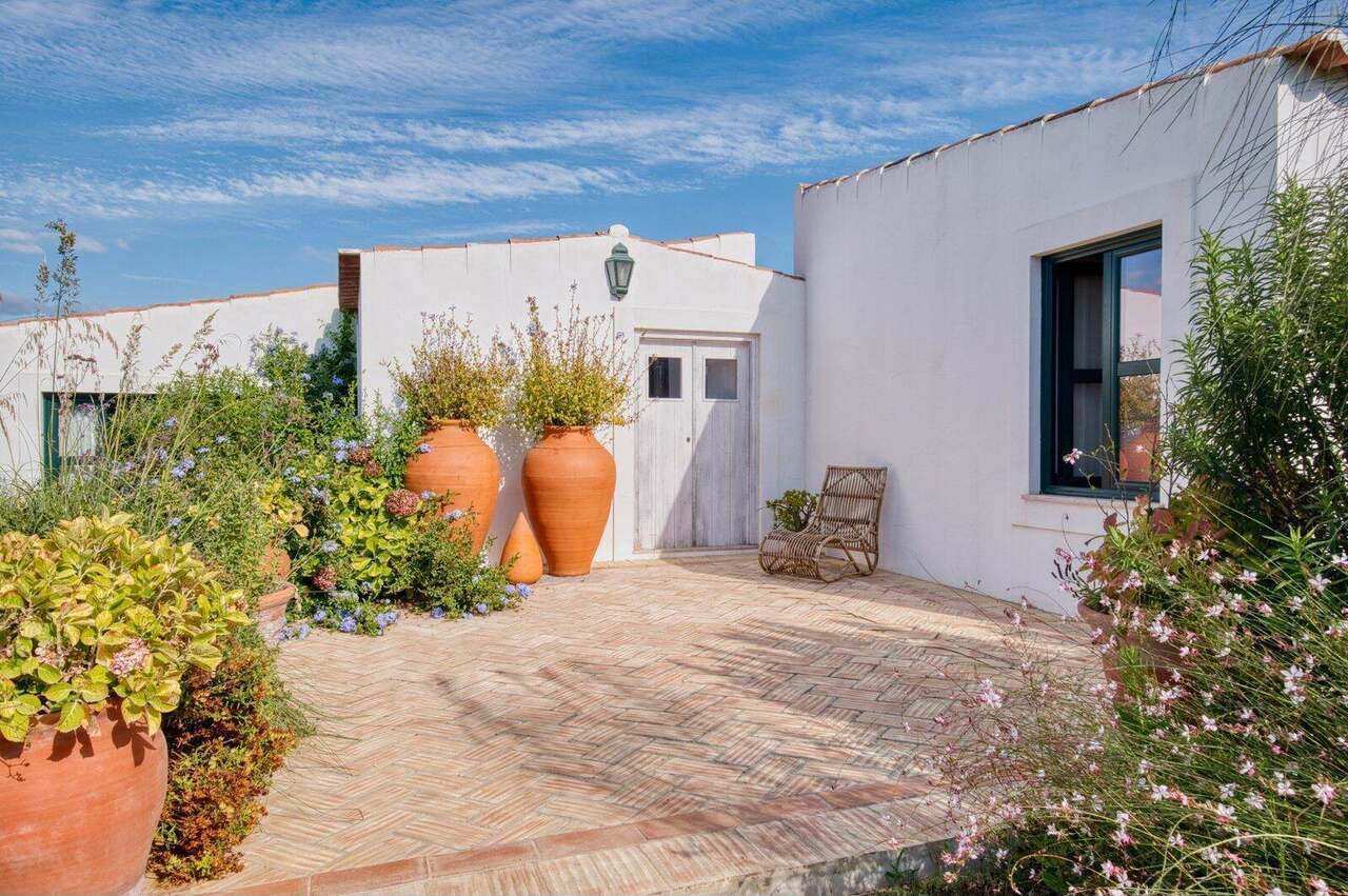 The inner courtyard, planted urns by the bedroom wing